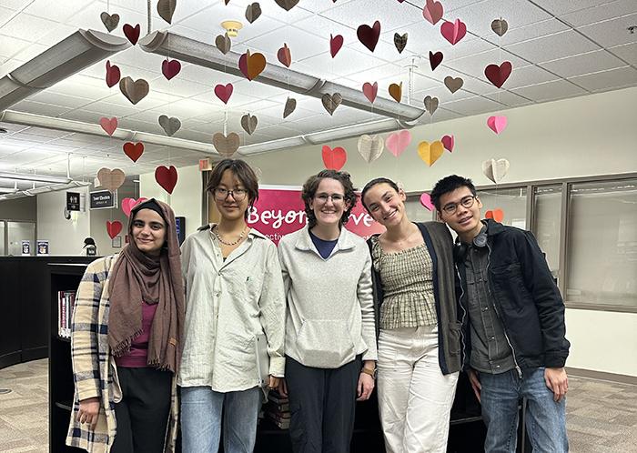 ELSA standing in front of their curated library display "Beyond Love".